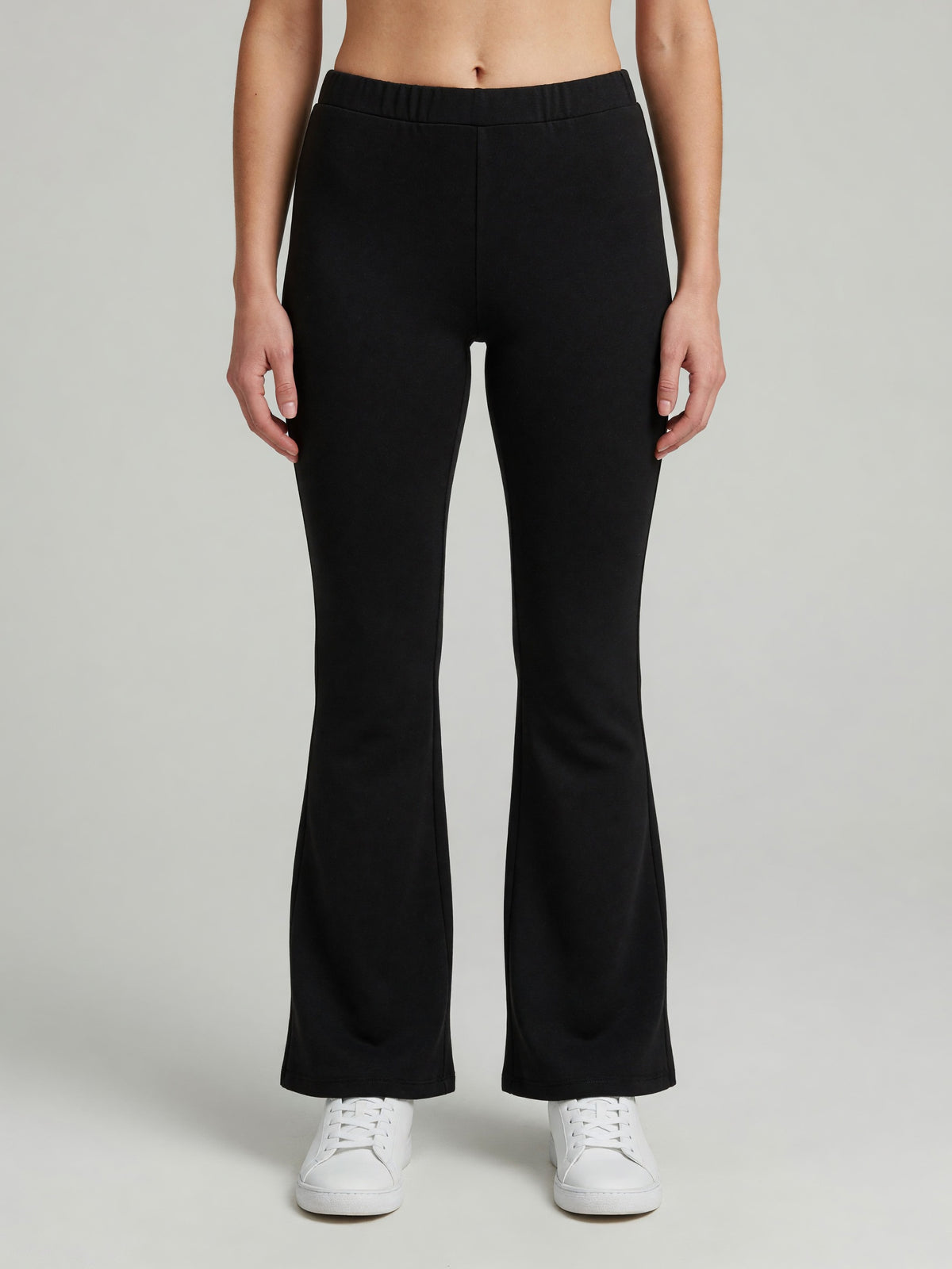 Slim Flare Sweatpant in Black, worn, front