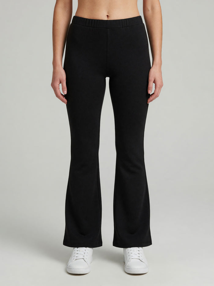 Slim Flare Sweatpant in Black, worn, front